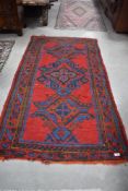 A Turkish Ushak style rug having bright red ground and multicoloured pattern, approx. 179 x 94cm