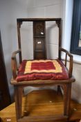 A Chinese hardwood carver chair, having markings to back panel and reinforced foot rail, width