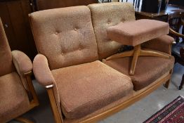 A modern Ercol three piece lounge suite comprising two settees and electric recliner chair, on