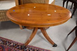 A reproduction Regency yew wood coffee table having oval top, approx. 90 x 60cm