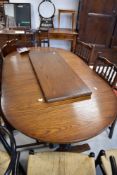 A vintage oak oval extending dining table and set of six (four plus two) dining chairs, approx.