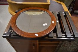 A vintage folding luggage stand and a circular oak framed wall mirror, diameter approx. 47cm