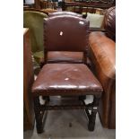A pair of early to mid 20th Century oak and leather chairs having turned frames