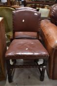 A pair of early to mid 20th Century oak and leather chairs having turned frames