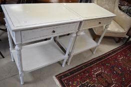 A pair of reproduction side tables in the classical style , with frieze drawers and shabby chic