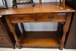 A nice quality oak reproduction side table, with double frieze drawers and under shelf, width