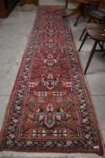 A traditional Persian style carpet runner, approx 372 x 75cm