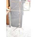 Black metal folding and extendable music stand, currently 130cm in height, with the ability to