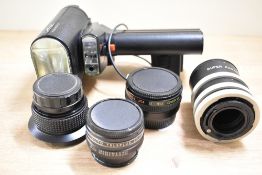 Assortment of camera accessories. An AICO semi fish-eye lens attachment, a Metz G15 flash unit, 2