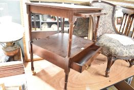 A reproduction mahogany etage style occasional table having turned frame and brass castors, width