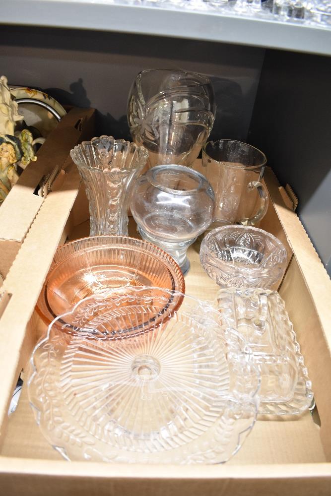A collection of assorted glassware including a large crystal vase, a heavy vase with indistinct