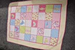A 1990s-2000s quilt, 100% cotton, padded and stuffed, having a colourful printed patchwork design