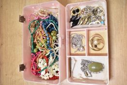 A vintage pink plastic jewellery box with a cameo to lid, containing a small assortment of costume