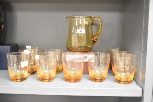 A quantity of mid 20th-century Whitefriars Crystal amber studio glass pitcher set with matching