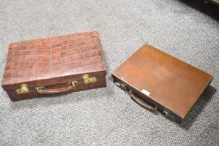Two vintage leather briefcases with metal hard wear, (2), condition is consistent with age and use.