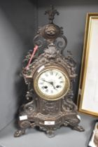 A large 19th-century French Rococo-style gilt metal mantel clock, having Roman hours and Arabic
