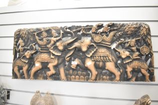 A large 20th-century hand-carved wooden wall panel, presumed to be from Southeast Asia, depicting