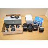 A collection a lenses. A Canon 100mm f2.8, a Carl Zeiss Jena 135mm f3.5, a Hanimex 28mm f2.8,