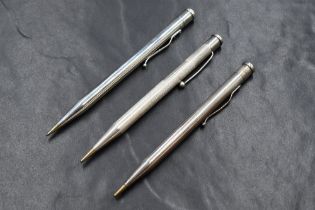Three round Yard o Led hallmarked Silver mechanical pencils. Dated London 1938, 1948 and 1965