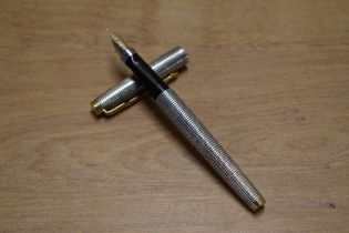 A Parker 75 converter fill fountain pen in Sterling Silver Cisele with gold trim having Parker 14K