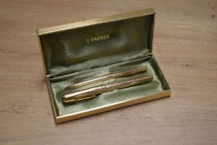 A boxed Parker 61 Insignia capillary fill fountain pen and mechanical pencil in Rolled Gold