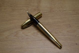 A Sheaffer Triumph Touchdown fill fountain pen in Gold Fill having Sheaffer's 14K nib. Circa 1973.