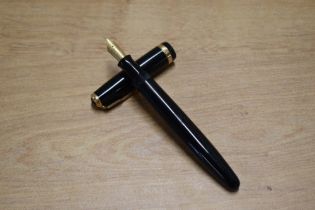 A Parker Duofold button fill fountain pen in Black with broad decorative cap band having Parker