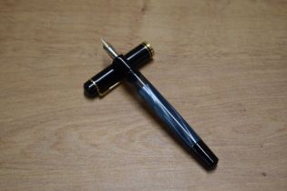 A Pelikan M200 piston fill fountain pen in Blue Marble with broad and narrow ca band having