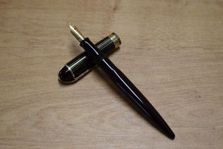 A Wahl Eversharp Skyline lever fill fountain pen in Plum with striped Green and Black cap with