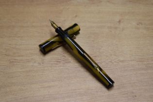 A Banker lever fill fountain pen in Green and Black having Banker 14K Gold Plated nib. Circa 1935.