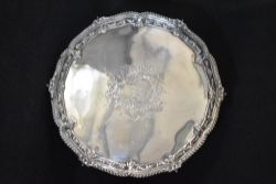 A Victorian silver salver, of circular form having a gadrooned and scroll rim with a central