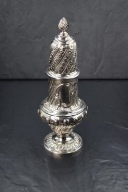 A Victorian silver sugar caster, the spiral finial over the pierced top, having a bulbous body