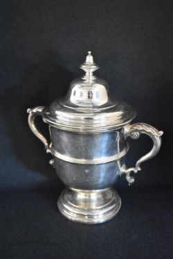 An impressive Victorian silver lidded trophy, of traditional form having a finial top over a moulded