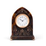 A TORTOISESHELL DESK CLOCK of lancet form, the arched case inlaid with gilt ribbon and foliate