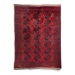 AN AFGHAN RED GROUND CARPET, 340CM X 252CM The large centre field woven with three rows of