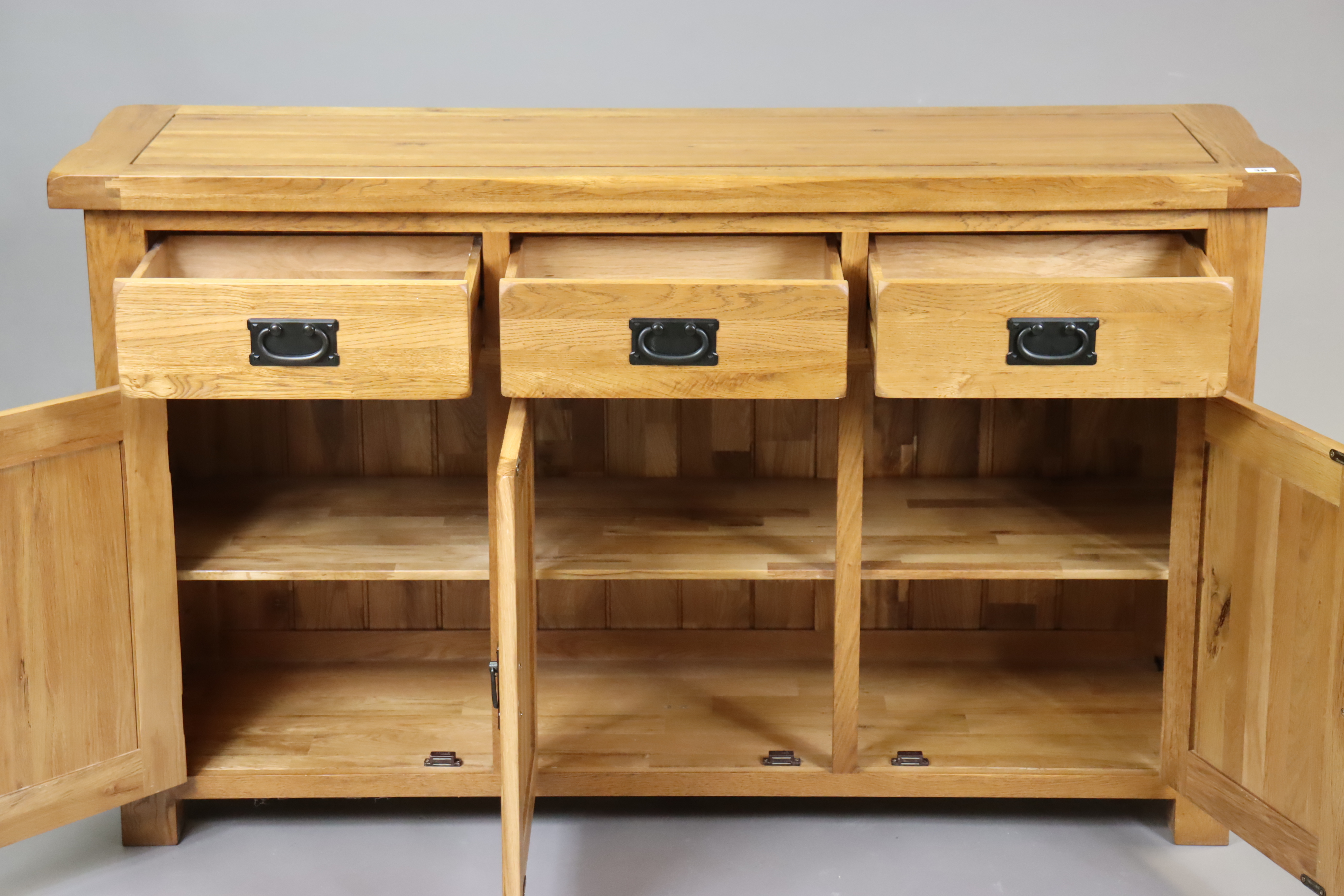 A light oak sideboard fitted three frieze drawers above cupboards enclosed by three panel doors, - Image 2 of 3