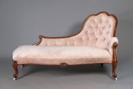 A Victorian walnut frame chaise longue with carved decoration & buttoned back, upholstered light