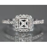 A diamond dress ring, the square-cut centre stone approx. 0.3 carat, set within a border of small