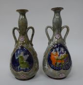 A pair of Royal Doulton stoneware twin handled bottle vases with narrow, swollen necks and flared