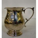A silver Christening tankard with an ear shaped handle  Birmingham 1923  (approx. 162grms)