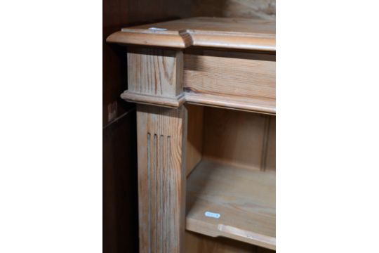 A modern pine low open bookcase with two adjustable shelves, on a plinth base - Image 2 of 3