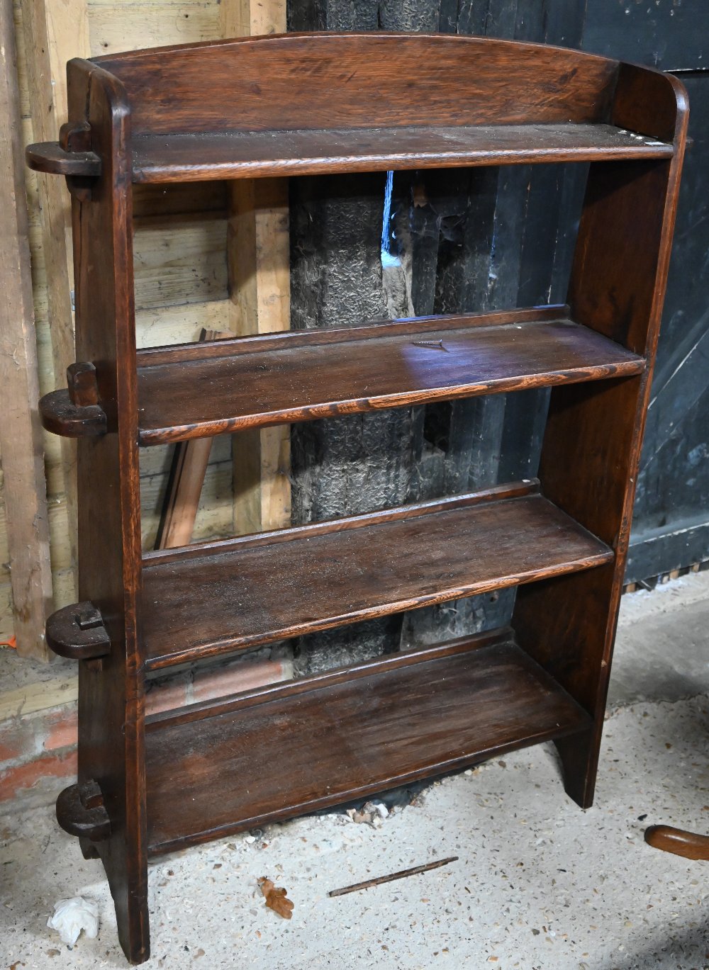 An Arts & Crafts oak open bookcase of four graduated shelves