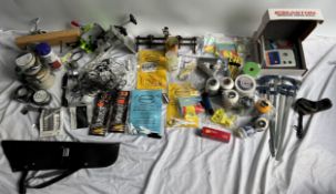 A collection of archery accesories including an Easton arrow scales, bow strings, clamps, tape,