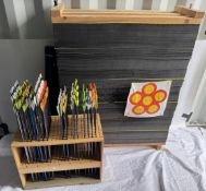 A large collection of archery arrows together with a rack, tubes and target backing section,