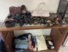A collection of hand bags, belts,