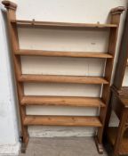 A set of pine hanging shelves, on shaped base,