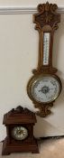 An oak aneroid barometer with a ceramic dial and a mercury thermometer together with a bracket
