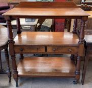 A Victorian mahogany dumb waiter with a rectangular moulded top above a central shelf with two