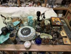 Black forest carved figures together with a glass jug, glass vases, icons, pottery plates,