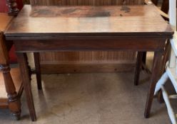 A 19th century mahogany tea table with a rectangular foldover top on square legs